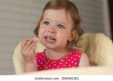 A Small European Child Does Not Want To Eat Vegetable And Egg Lasagna And Rubs His Eyes With His Hands. The Kid Is Naughty Before Eating.