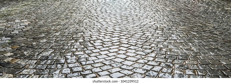 Small European Street  . Rainy Day, Wet Cobble Stones. Empty Road In City Center.Paving Stone Road 