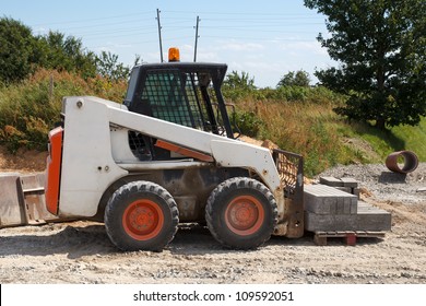 Small Excavator Bobcat At Construction Site