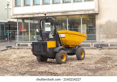 Small excavator on construction road. Tough heavy duty dump truck. Truck for hauling dirt on the road. construction site dumper mini load dumper
