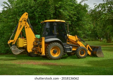 Small Excavator At Work Making Garden Pond