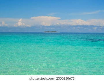 Small exotic atoll island with deep turquoise and emerald open ocean sea - Shutterstock ID 2300250673
