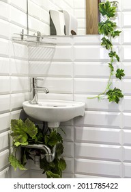 Small faience sink with metal faucet in corner of lavatory or bathroom. Fragment of interior - Shutterstock ID 2011785422