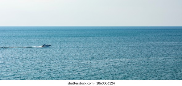 A Small Family Boat Headed From Left To Right On The Lake Michigan. Blue Water Is Calm On A Clear Sunny Day. Boast Is Isolated In Left Of Photo And Is A Great Wallpaper. Pure Michigan At Arcadia