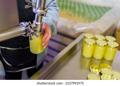 Small Family Business Food Production Area Hand Filling Glass Jars Of Sauce