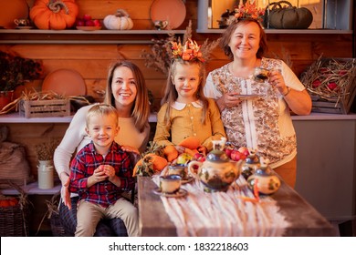 Small Family Celebrates Thanksgiving Together. Siblings And Parents. Visit Grandma. Festive Congratulation Dinner Outside On The Terrace Of Country House. Farming Harvest Festival. Veranda Decoration