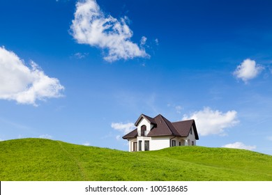 Small Family House On Green Field With Blue Sky