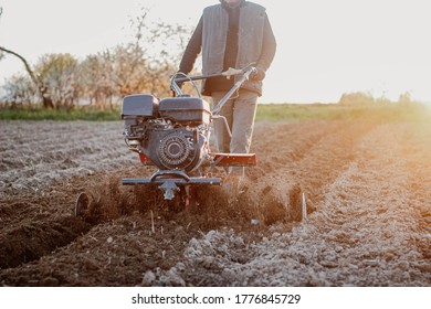 Small Farm Tractor Plows The Ground, The Work Of A Walk-behind Tractor.