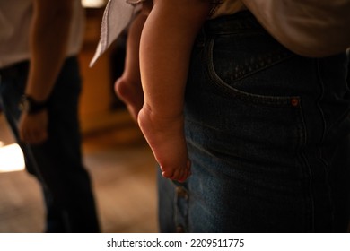 Small Feet Of A Child In A Dark Orthodox Church During The Sacrament Of Baptism