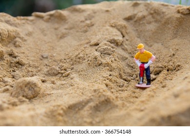 small figure of digger man working.