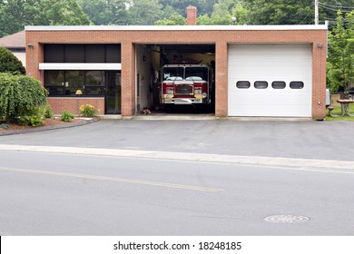 A small fire house with two garage bays.