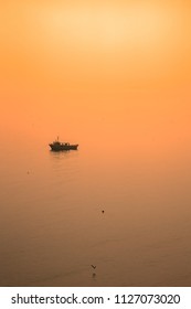 Small Fishing Boat In Cornish Bay At Dusk, Cornwall, England, UK