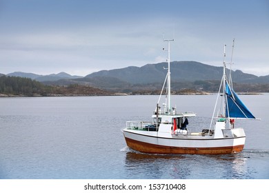 Small Fishing Boat In Fjord Of Norway