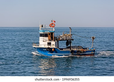 Small Fishing Boat With Nets Sailing Through Karadeniz Marmara Sea. Side View. Rumelifeneri, Istanbul, Turkey - June 5 2021.