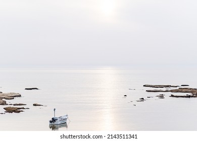A small fishing boat on the beach in Jaffa, on a foggy day. Concept for peace, quiet and serenity. High key photography. High quality photo - Shutterstock ID 2143511341