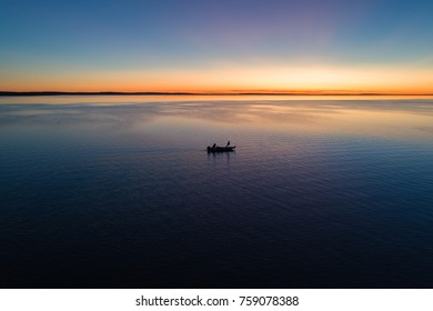 A Small Fishing Boat On Houghton Lake In Michigan At Sunrise