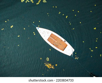 A Small Fishing Boat On A Middle Of Calm Lake. Top View.