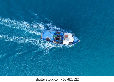 Small Fishing Boat At Sea - Aerial Image