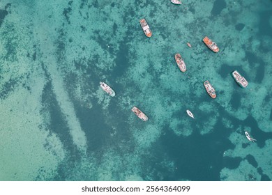 small fishing boats anchored close to the shore, aerial top view with a drone. - Powered by Shutterstock