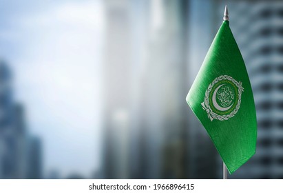 A small flag of Arab League on the background of a blurred background