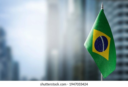 A small flag of Brazil on the background of a blurred background - Powered by Shutterstock