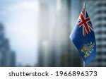 A small flag of South Georgia and the South Sandwich Islands on the background of a blurred background