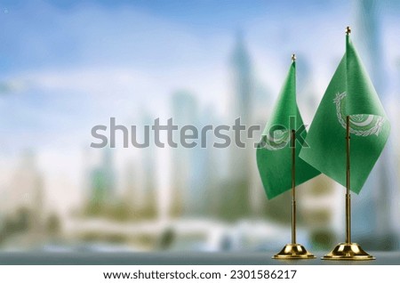Small flags of the Arab League on an abstract blurry background.