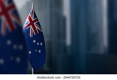 Small Flags Of Australia On A Blurry Background Of The City.