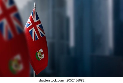 Small Flags Of Bermuda On A Blurry Background Of The City