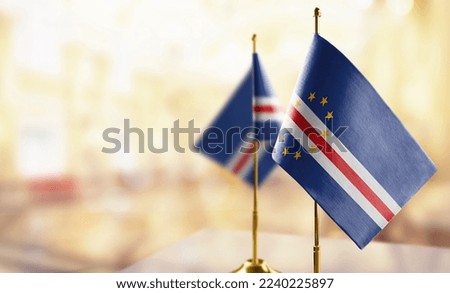 Small flags of the Cape Verde on an abstract blurry background