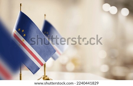Small flags of the Cape Verde on an abstract blurry background