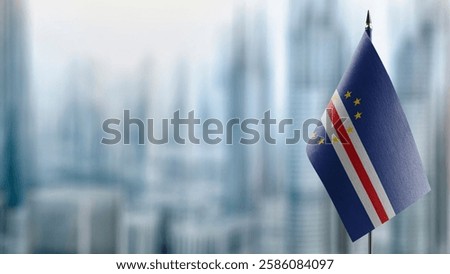 Small flags of the Cape Verde on an abstract blurry background.