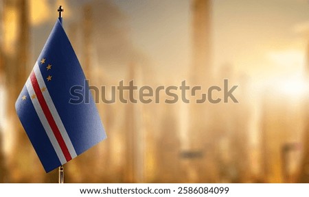 Small flags of the Cape Verde on an abstract blurry background.