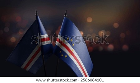 Small flags of the Cape Verde on an abstract blurry background.