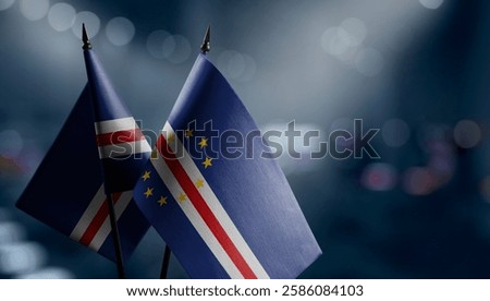 Small flags of the Cape Verde on an abstract blurry background.
