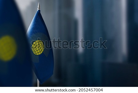 Small flags of Commonwealth on a blurry background of the city