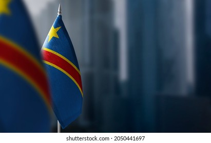 Small Flags Of Democratic Republic Of The Congo On A Blurry Background Of The City