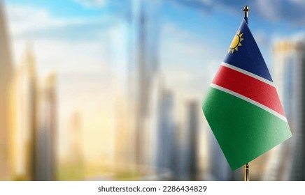 Small flags of the Namibia on an abstract blurry background.