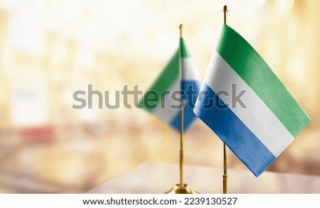 Small flags of the Sierra Leone on an abstract blurry background Stock photo © 