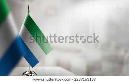 Small flags of the Sierra Leone on an abstract blurry background. Stock photo © 
