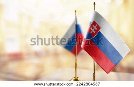 Small flags of the Slovakia on an abstract blurry background.