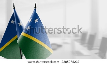 Small flags of the Solomon on an abstract blurry background.