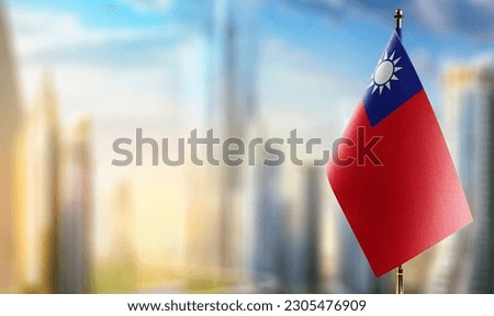 Small flags of the Taiwan on an abstract blurry background.
