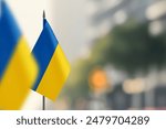 Small flags of Ukraine on a blurred background