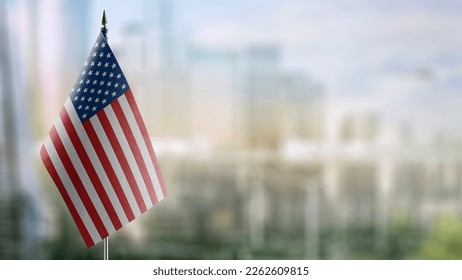Small flags of the USA on an abstract blurry background. - Shutterstock ID 2262609815