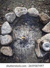 Small flame flickers inside rock-ringed pit.