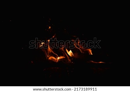 Small flames from a bonfire at night