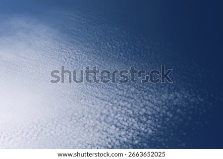 Small fleecy clouds in the summer sky