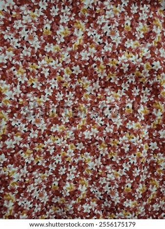 Small flower pattern is blooming. Yellow, white, red flowers, bright colors, fabric texture, floral background.