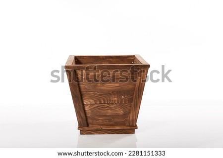 Small flower pot made of wood on a white background
